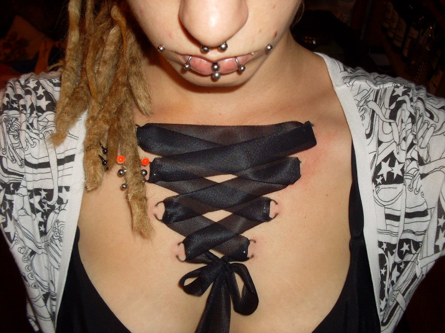 Black Ink Corset Piercing On Chest