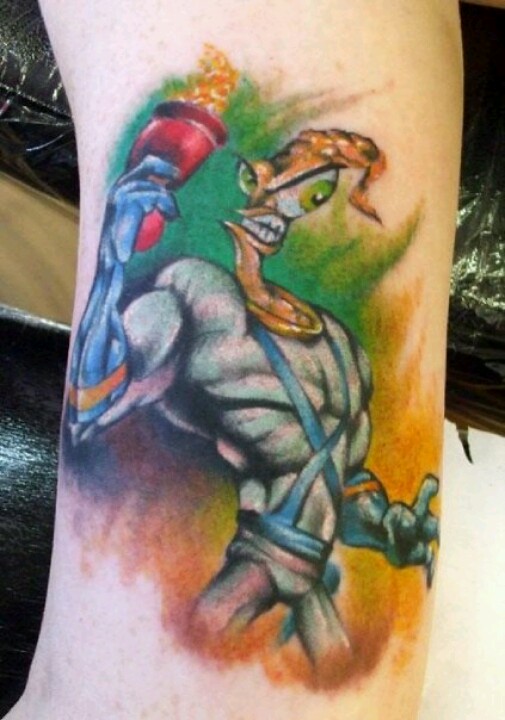 Colorful Angry earthworm Jim Holding Gun Tattoo