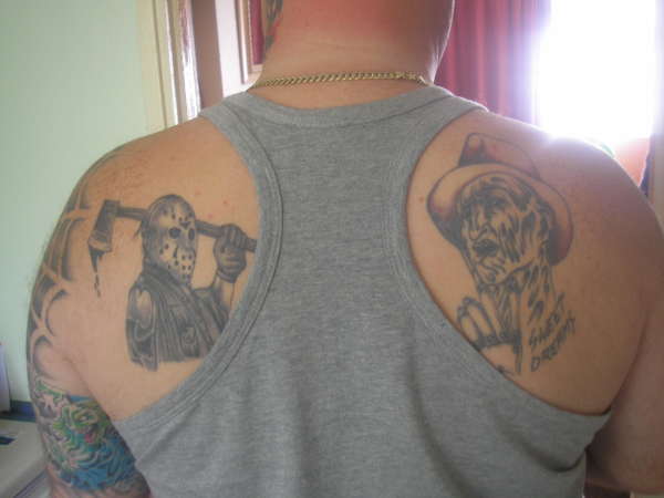 Simple Grey And Black Jason Vs Freddy Tattoo On Back Shoulder