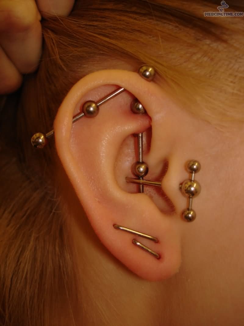 Industrial And Staple Piercing On Right Ear Lobe