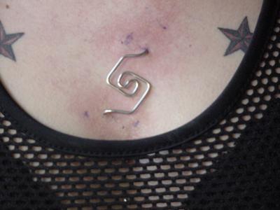 Silver Staple Piercing On Chest