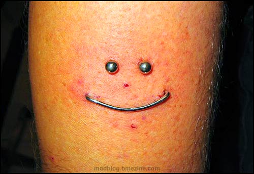 Smiley Staple Piercing on Bicep