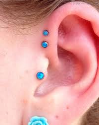 Tragus And Forward Pinna Piercing With Blue Studs