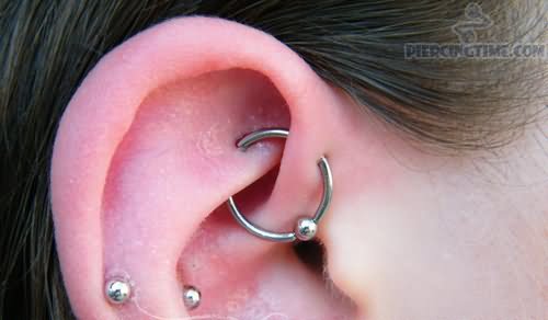 Cartilage And UFO Piercing On Girl Right Ear