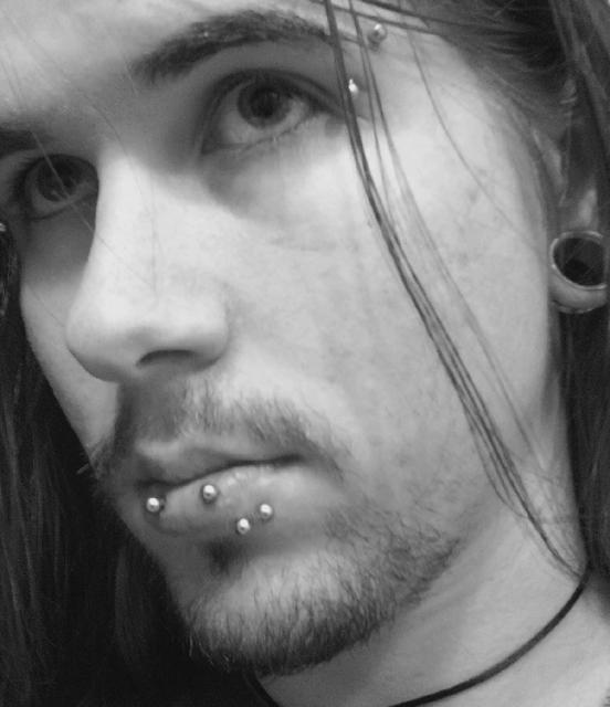 Left Ear Lobe And Horizontal Lip Piercing With Silver Barbell