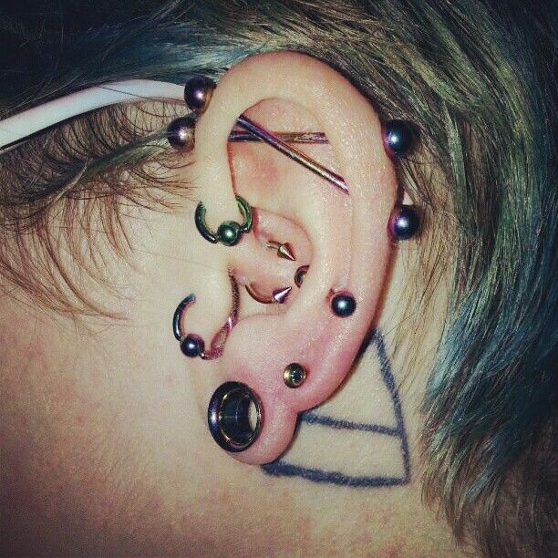 Left Ear Stretched Lobe And Dual Scaffold Piercing For Girls