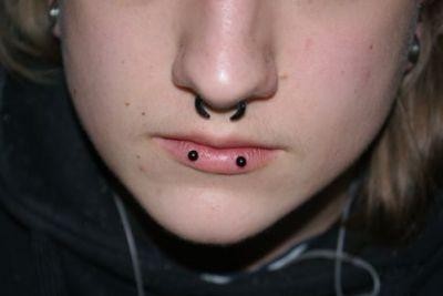 Septum And Horizontal Lip Piercing With Black Barbell