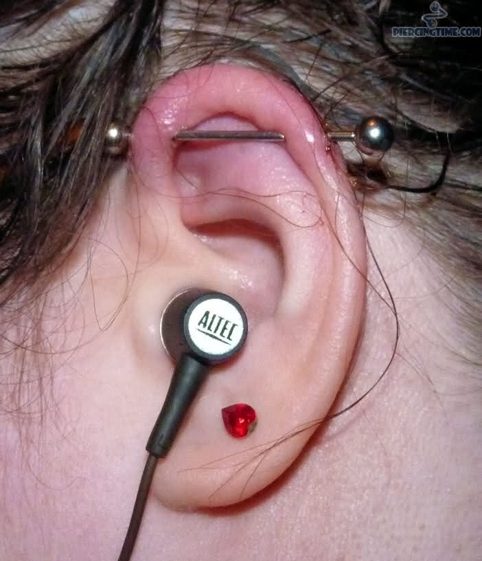 Silver Barbell Scaffold Piercing On Girl Left Ear