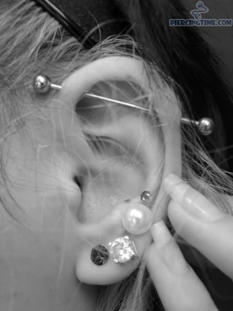 Triple Lobes And Scaffold Piercing On Girl Left Ear