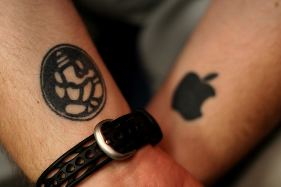 Apple Logo Silhouette With Ganesha Tattoos On Both Wrists