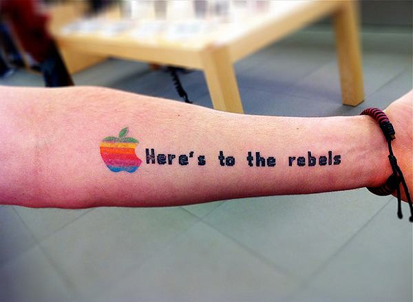 Colorful Iphone Apple Logo With Lettering Tattoo On Forearm