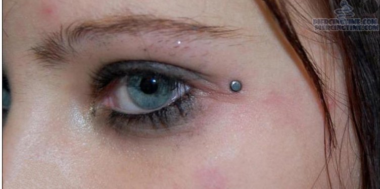 Crow Feet Piercing With Single Dermal