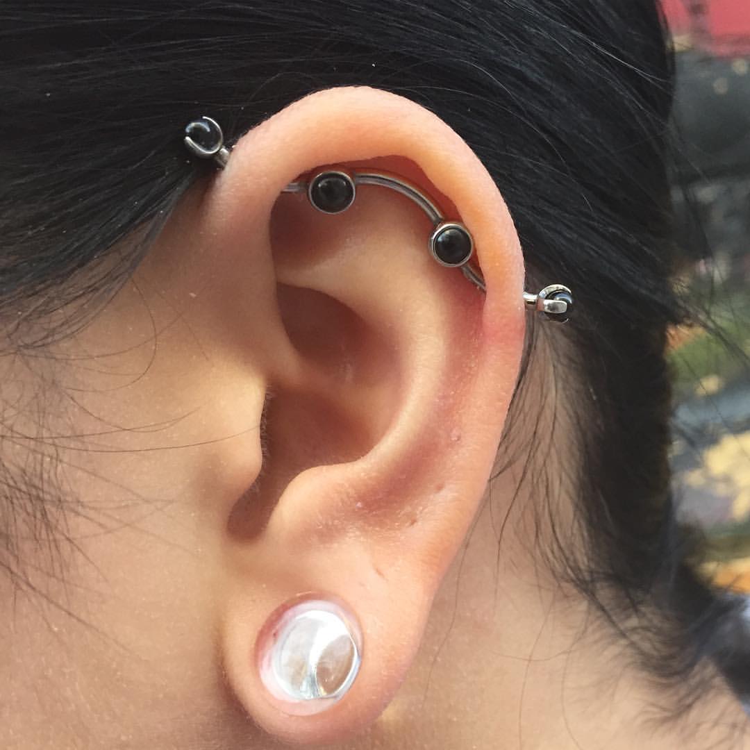 Custom Industrial Piercing With Black Stones In Barbell