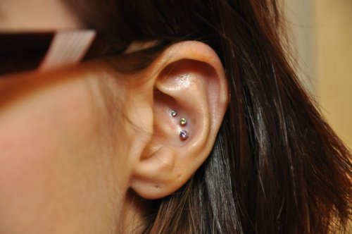 Dual Conch Piercing On Girl Left Ear