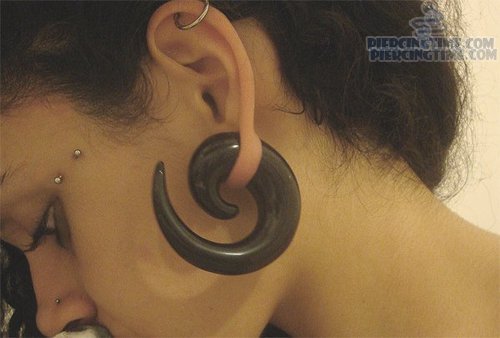 Ear Spiral And Crow Feet Piercing With Barbell