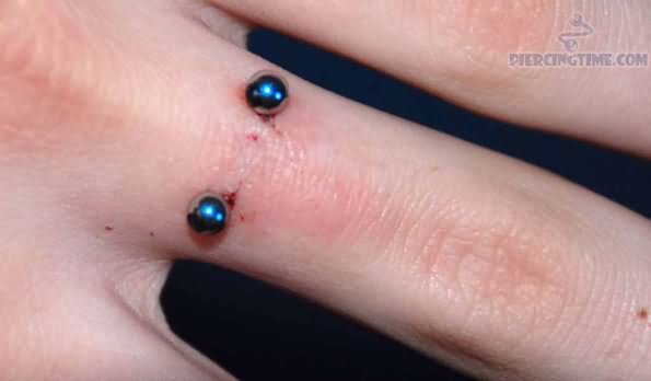 Finger Ring Piercing With Blue Barbell