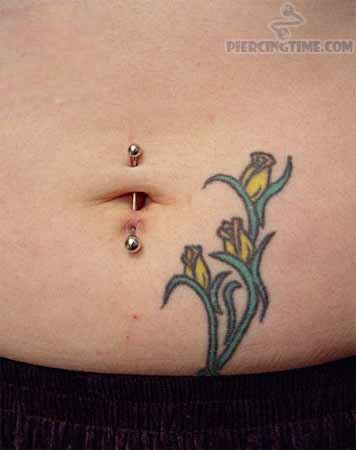 Flowers Tattoo And Vertical Industrial Navel Piercing