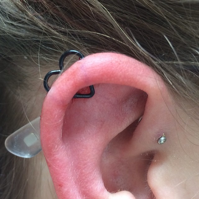 Forward Helix Ear Heart Piercing With Black Heart Ring