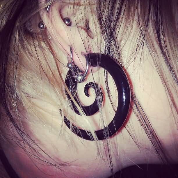 Girl Right Ear Lobe Piercing With Black Spiral Ring