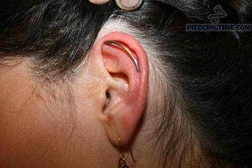 Girl Showing Her Custom Industrial Piercing