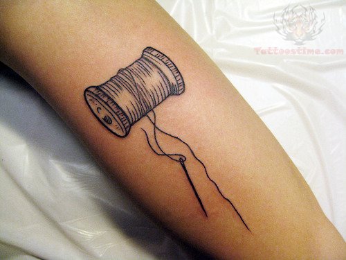 Grey Ink Spool Tattoo On Arm