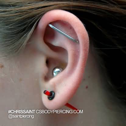 Inner Conch And Custom Industrial Piercing On Girl Left Ear