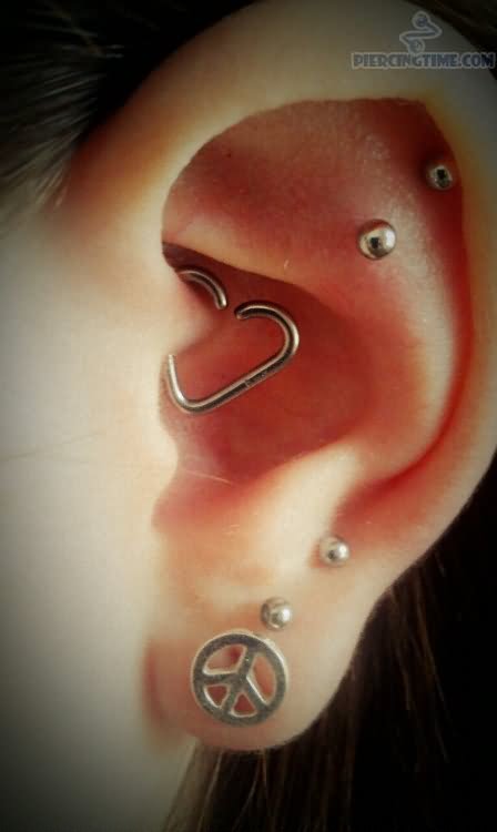 Left Ear Lobe Piercing With Peace Stud And Ear Heart Piercing