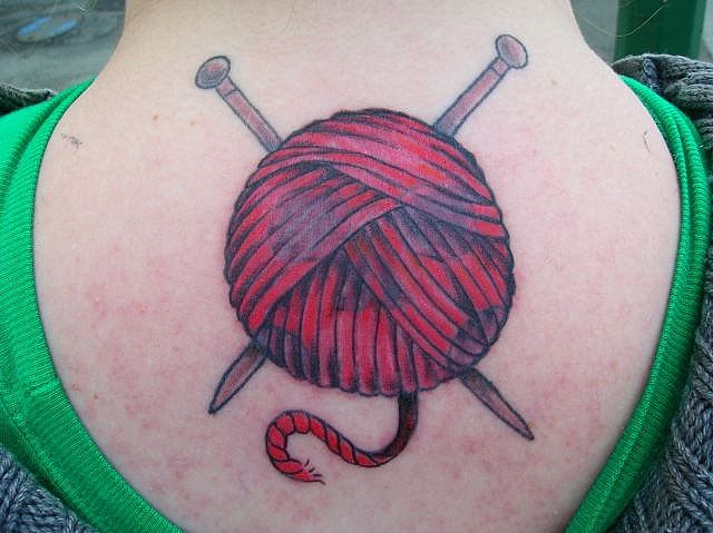 Needles With Yarn Ball Tattoo On Upper Back For Girls