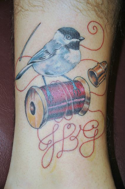 Nice Bird On Spool Tattoo On Ankle