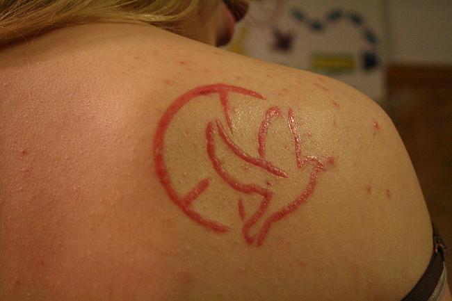 Peace Dove Scarification Tattoo On Right Upper Shoulder