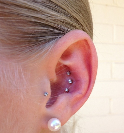 Pearl Lobe With Tragus And Dual Conch Piercing