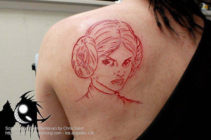 Princess Leia Scarification Tattoo On Left Back Shoulder