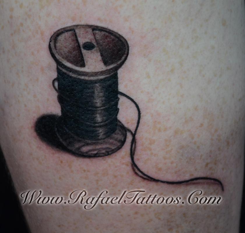 Realistic Spool Of Thread Tattoo