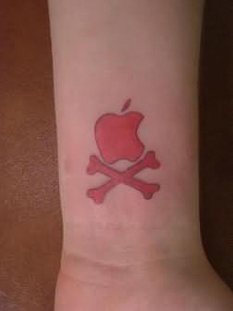 Red Ink Apple Logo With Cross Bones Tattoo On Wrist