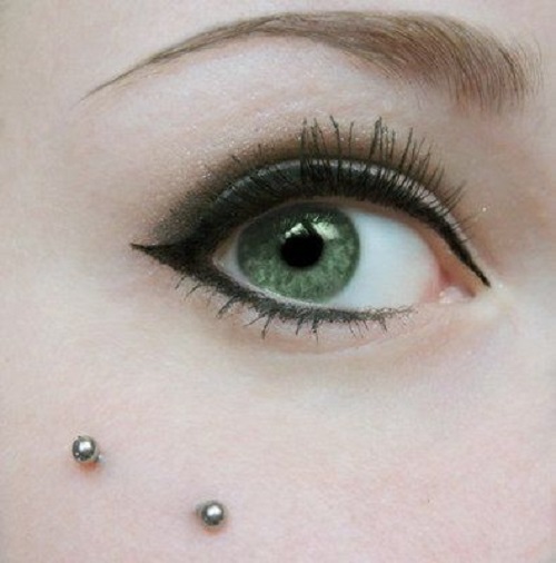 Silver Barbell Crow Feet Piercing On Right Eye