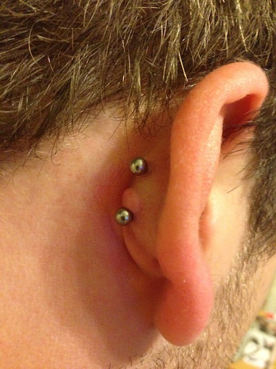 Silver Studs Double Conch Piercing On Man Right Ear