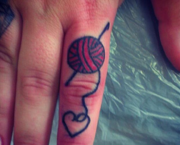 Small Heart Made Of Yarn Thread Tattoo On Finger