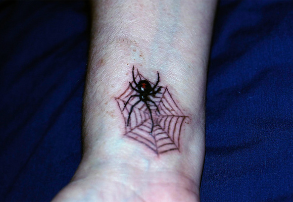 Small Latrodectus And Web Tattoo On Wrist