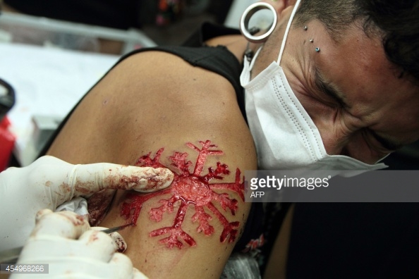 Snowflake Scarification Tattoo On Right Shoulder