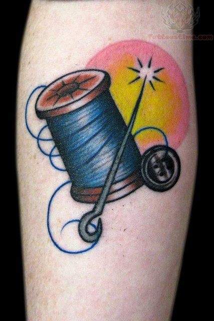 Spool Needle And Button Tattoo On Arm