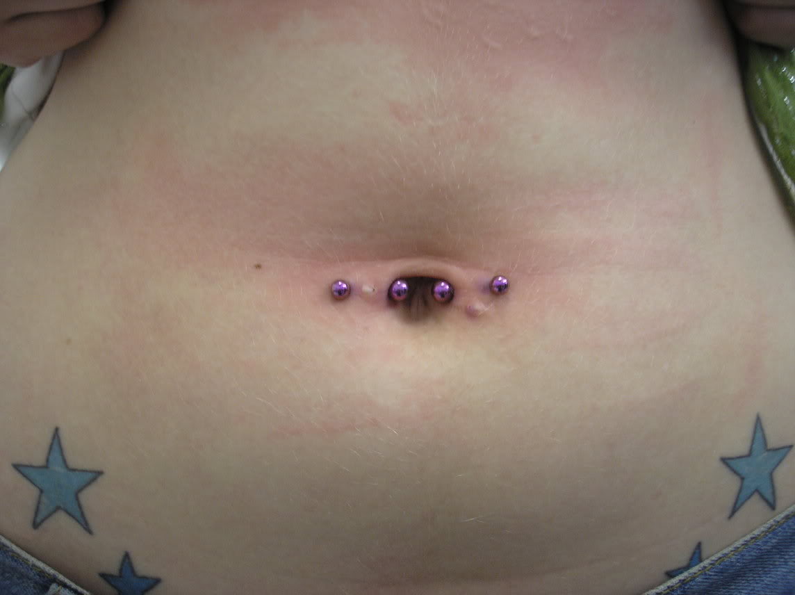 Star Tattoos On Hips And Industrial Navel Piercing With Purple Barbells