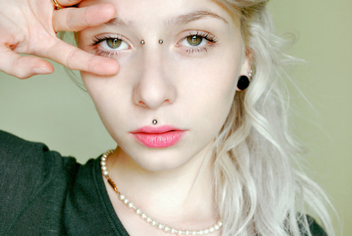 Trendy Girl With Medusa And Earl Piercing