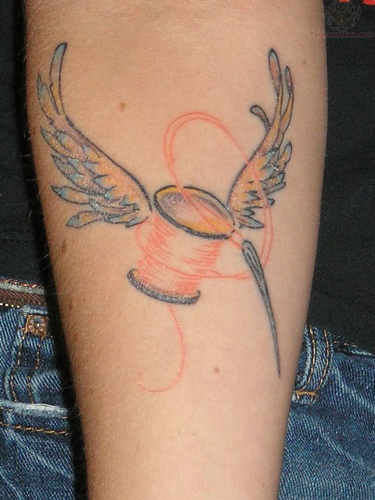 Winged Spool With Needle Tattoo On Arm Sleeve