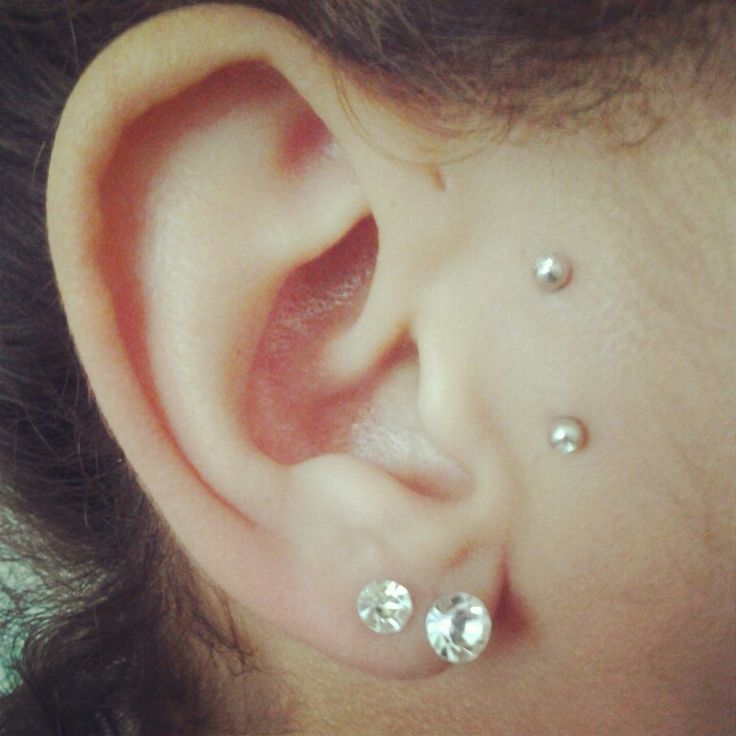 Double Lobes Piercing With Diamond Studs And Surface Tragus Piercing