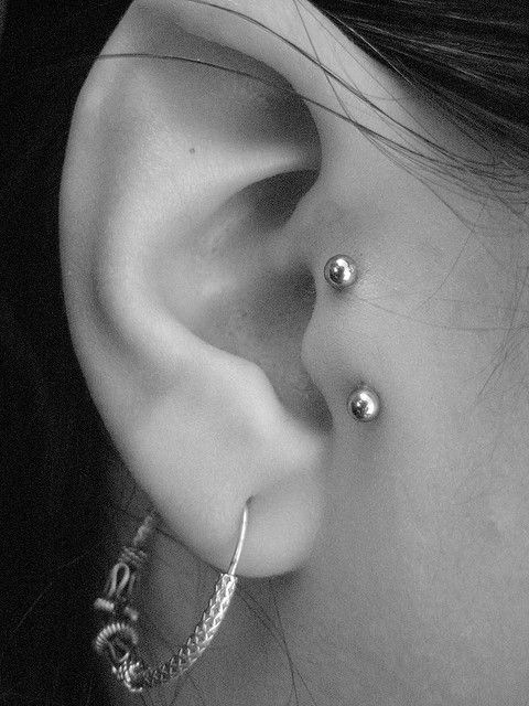 Girl Right Ear Lobe and Surface Tragus Piercing