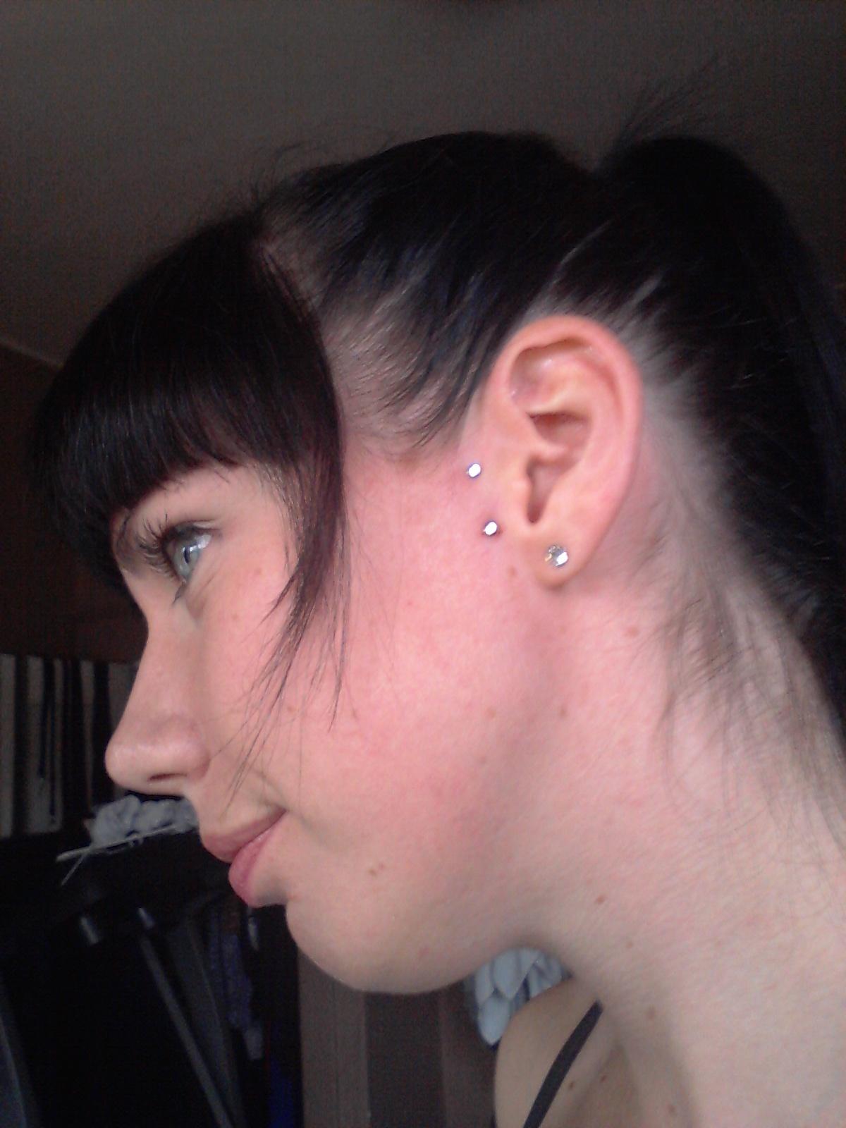 Girl With Lobe And Surface Tragus Piercing