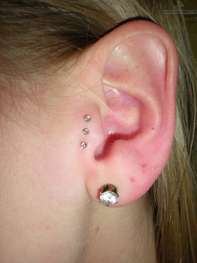 Left Ear Lobe And Surface Tragus Piercing Idea