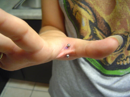 Silver Barbell Hand Web Piercing On Right Hand