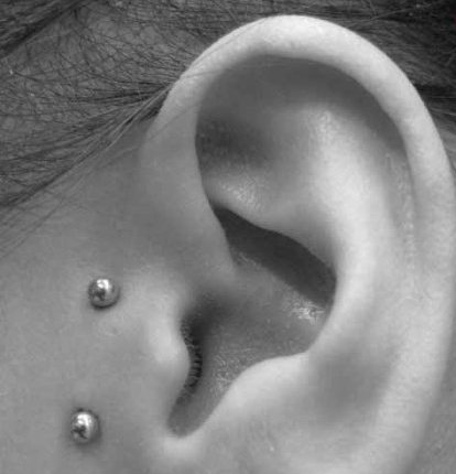 Surface Tragus Piercing On Left Ear