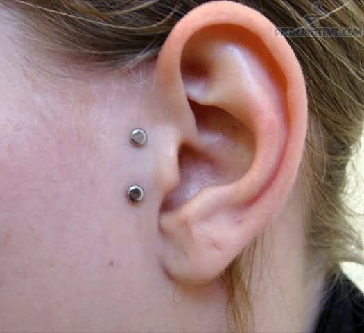 Surface Tragus Piercing With Silver Dermals